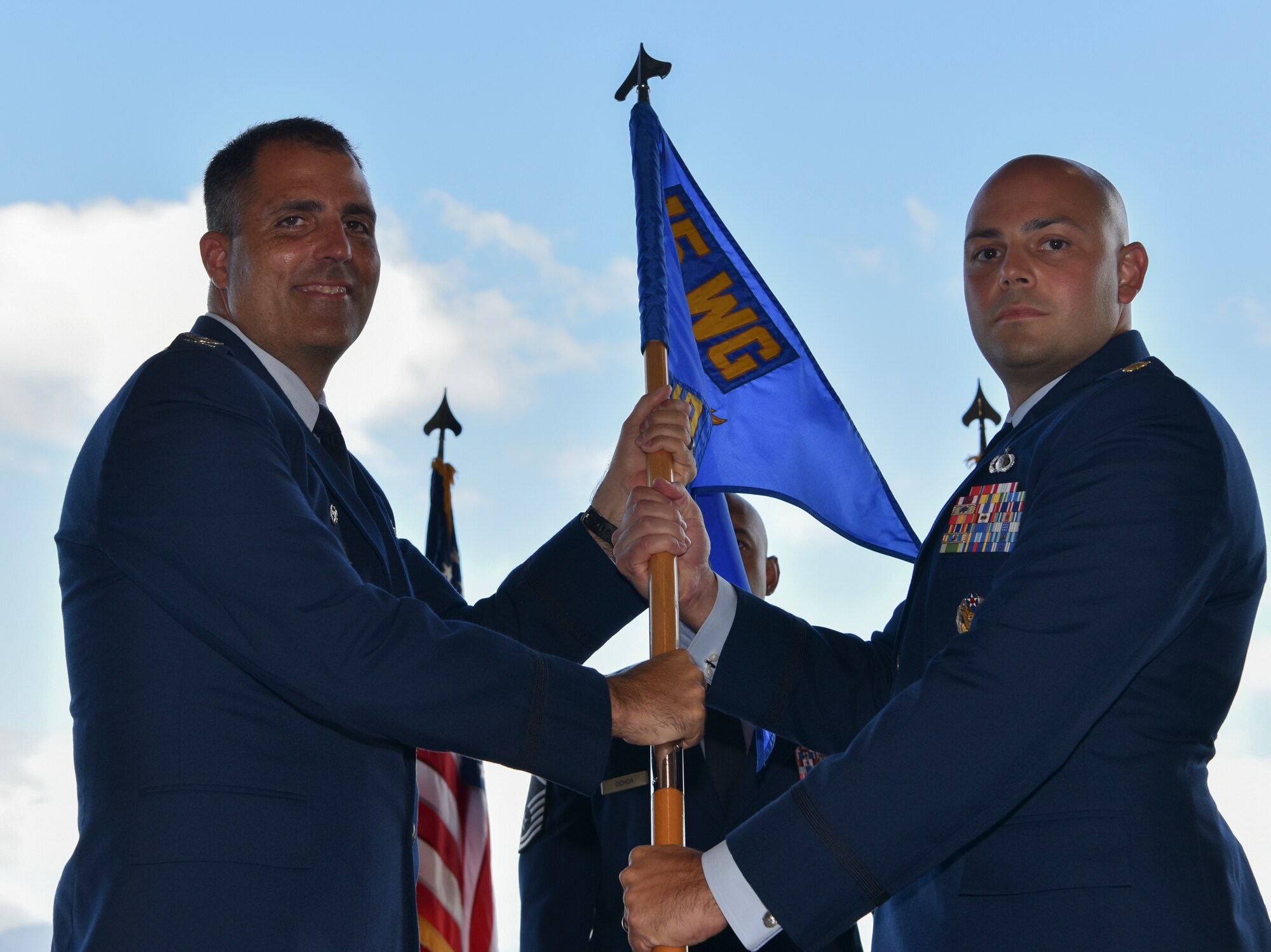 Maj. Zachary R. Mason, assumes command of the 15th Comptroller Squadron by accepting the guidon from Col. Daniel Dobbles, 15th Wing commander, during the 15th CPTS change of command ceremony at Joint Base Pearl Harbor-Hickam, Hawaii, July 12, 2021. The Airmen of  CPTS support more than 38,000 personnel and families in Hawaii. (U.S. Air Force photo by Tech. Sgt. Anthony Nelson Jr.)