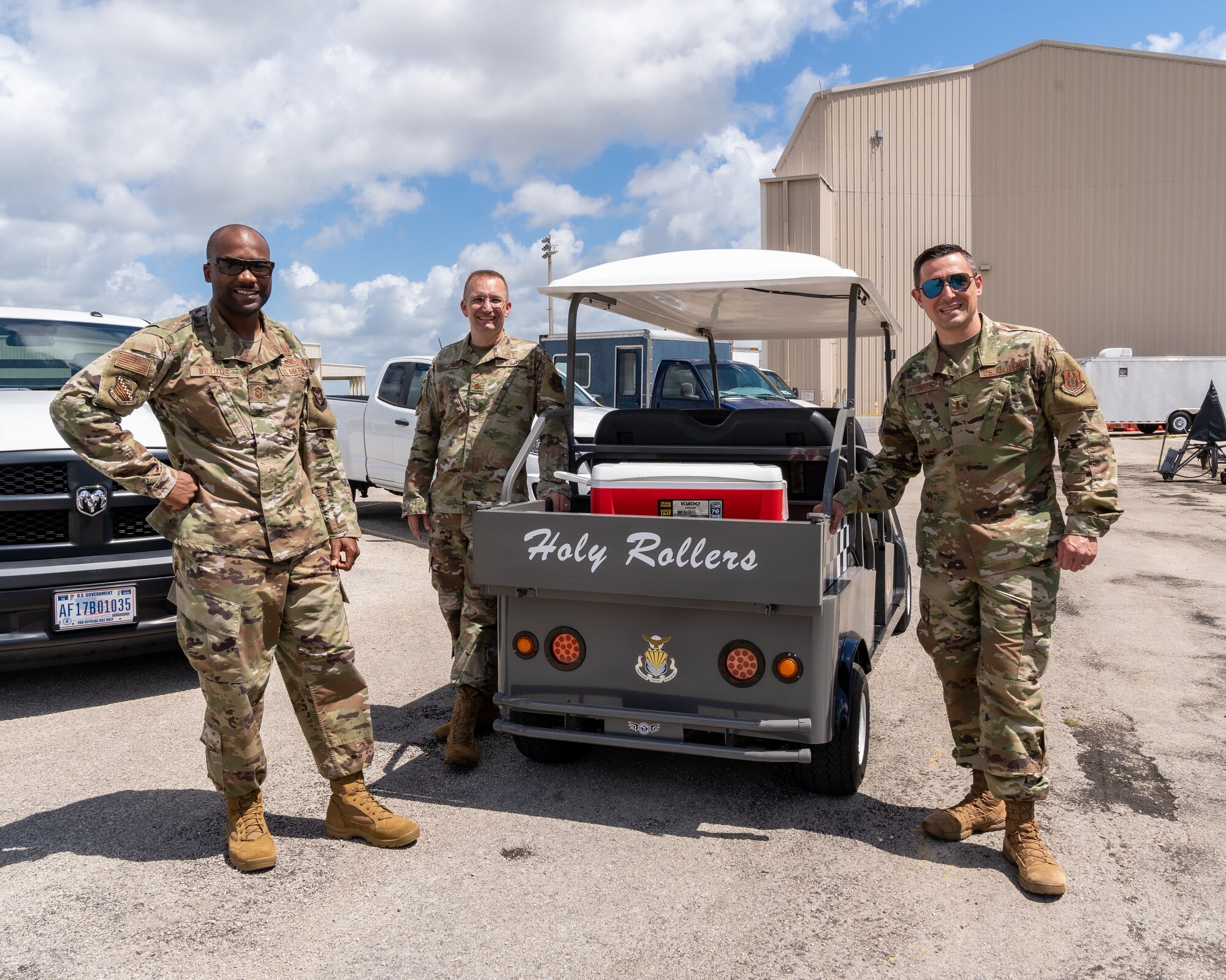 From left, Senior Master Sgt. Paul Williams, Chaplain (Maj.) John Rollyson and 2nd Lt. Brian A. Harris, Homestead Chaplain Corps, stand next to the Chaplain's cart dubbed "Holly Rollers" at Homestead Air Reserve Base, Fla., June 9, 2021. Harris finished his first evaluation tour with the Homestead Chaplain Corps, bringing him one step closer to becoming a military chaplain. (U.S. Air Force photo by Tech. Sgt. Lionel Castellano)