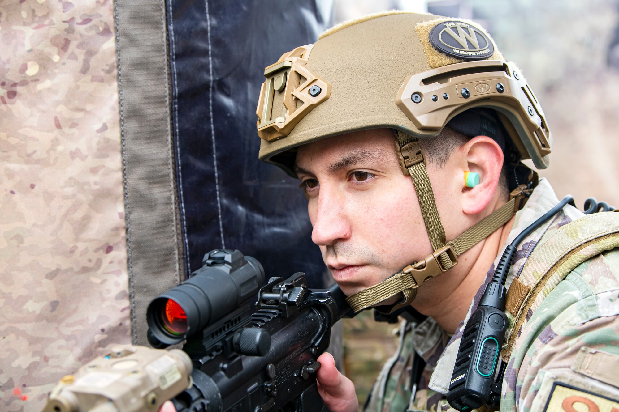 An Airman from the 422nd Security Forces Squadron, scans his perimeter during a tri-agency active shooter response exercise at RAF Croughton, England, June 30, 2021. Airmen from the 422nd SFS along with police officers from the Northamptonshire Police Department and Ministry of Defense, participated in multiple exercises to enhance their search and seizure tactics, strengthen local ties and gain rapport with their fellow officers. (U.S. Air Force photo by Senior Airman Eugene Oliver)