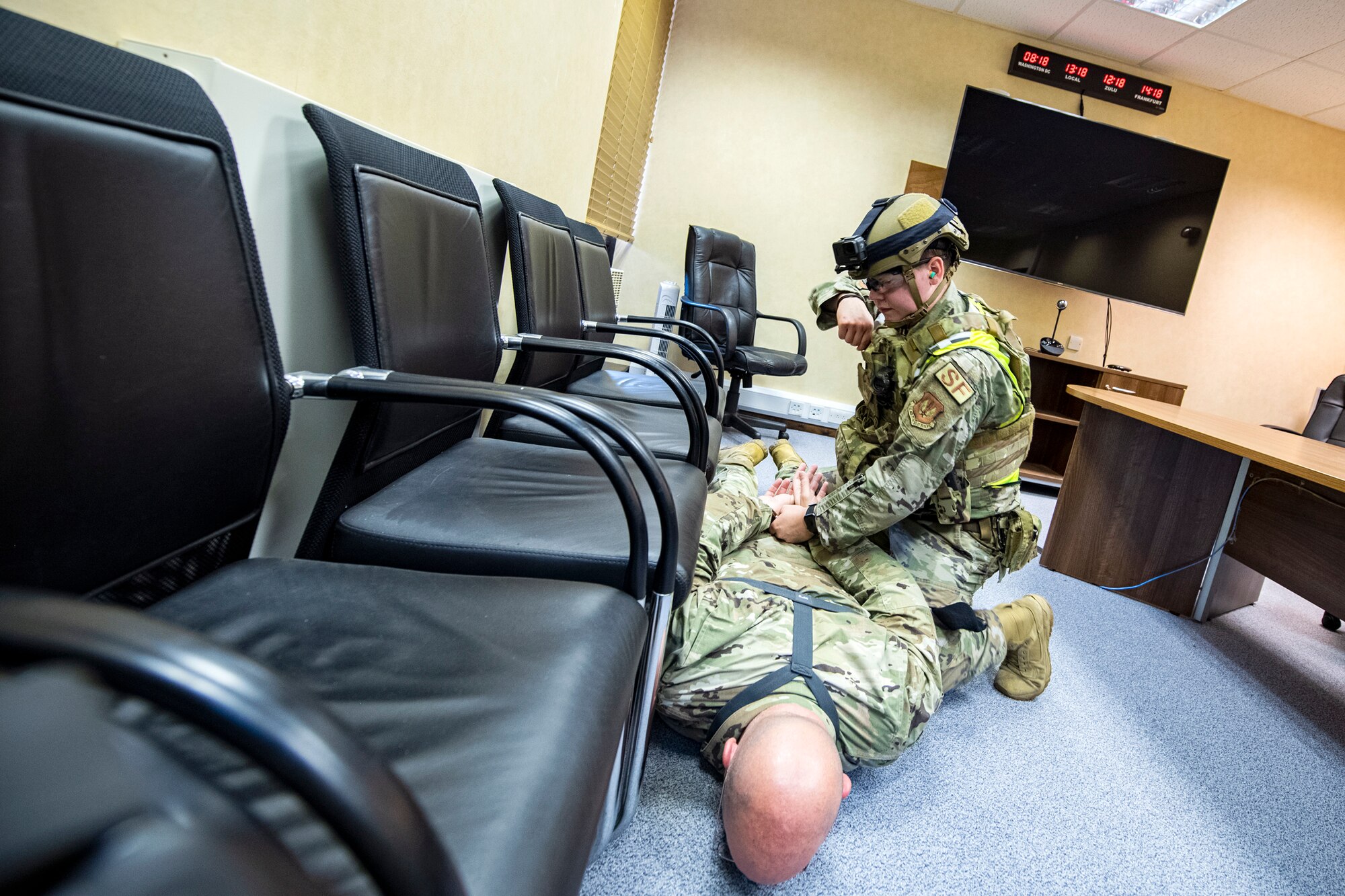 An Airman from the 422nd Security Forces Squadron, apprehends a simulated active shooter during a tri-agency active shooter response exercise at RAF Croughton, England, June 30, 2021. Airmen from the 422nd SFS along with police officers from the Northamptonshire Police Department and Ministry of Defense, participated in multiple exercises to enhance their search and seizure tactics, strengthen local ties and gain rapport with their fellow officers. (U.S. Air Force photo by Senior Airman Eugene Oliver)