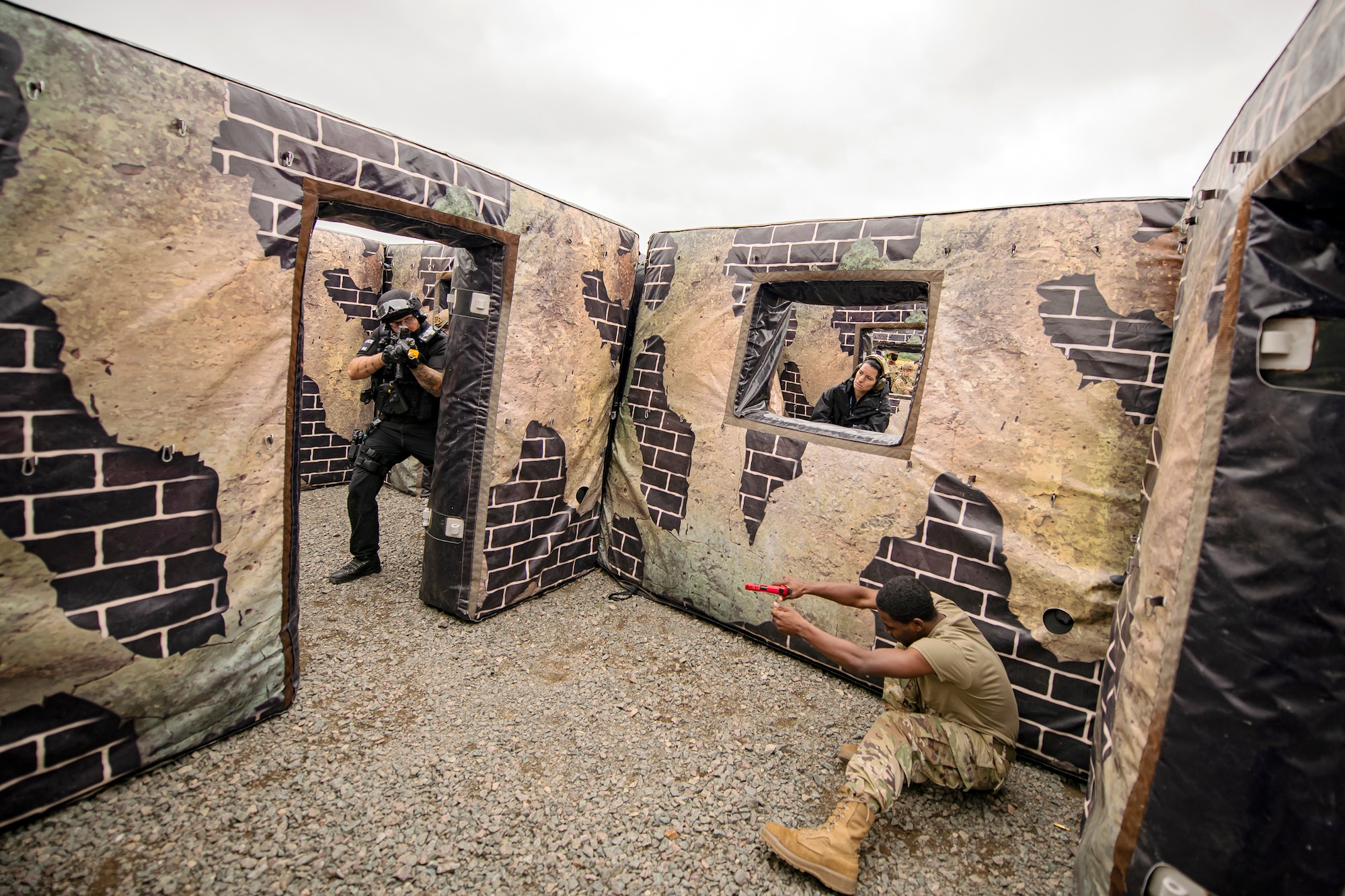 A Police officer from the Northamptonshire Police Department, neutralizes a simulated active shooter during a tri-agency active shooter response exercise at RAF Croughton, England, June 30, 2021. Airmen from the 422nd Security Forces Squadron along with police officers from the NHPD and Ministry of Defense, participated in multiple exercises to enhance their search and seizure tactics, strengthen local ties and gain rapport with their fellow officers. (U.S. Air Force photo by Senior Airman Eugene Oliver)