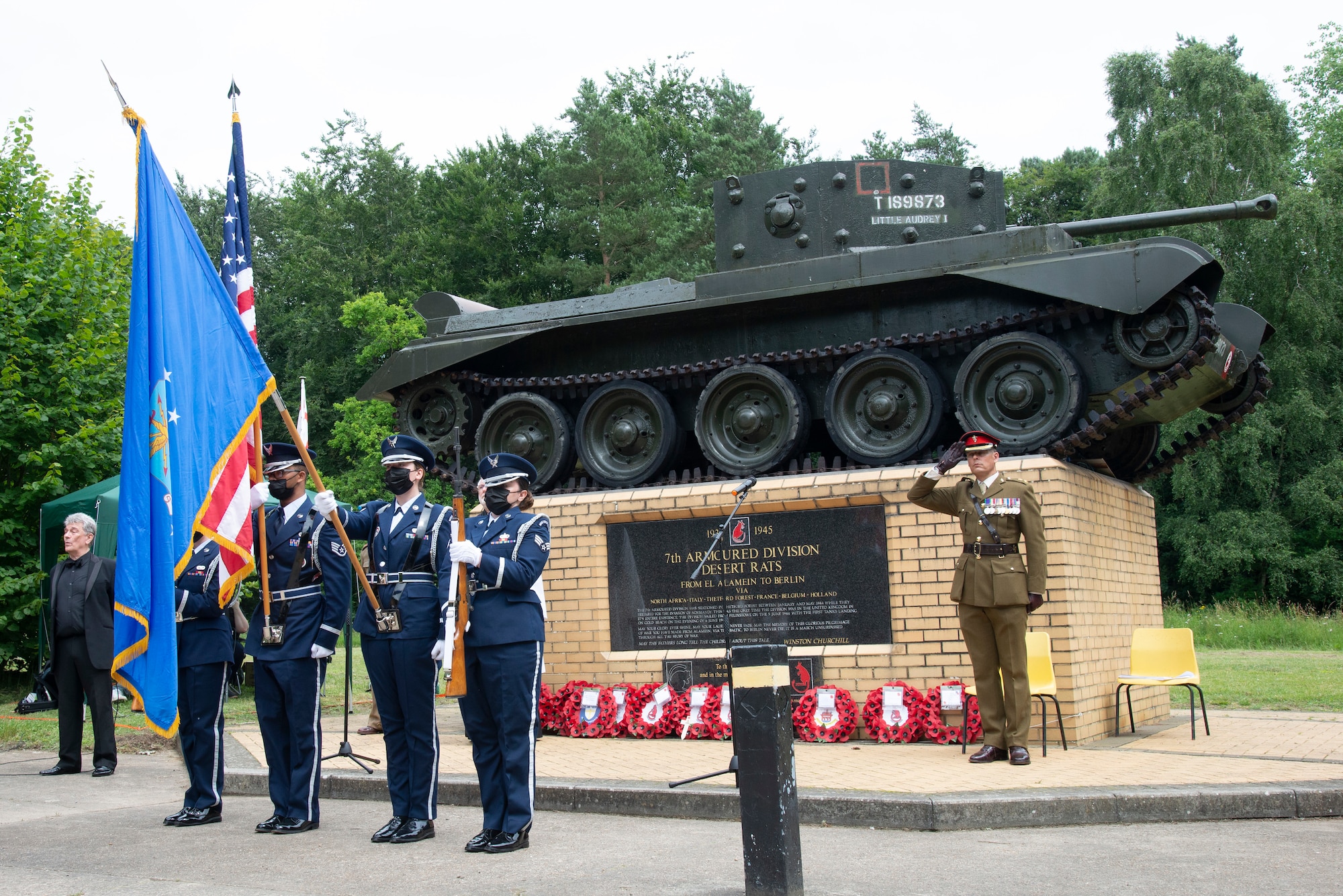 U.S. Air Force Honor Guard members assigned to the 100th Air Refueling Wing, Royal Air Force Mildenhall, England, present the colors at the Desert Rat memorial in High Ash, Thetford Forest, July 11, 2021. The honor guard presented the colors before the 7th Armoured Division Desert Rats memorial to commemorate soldiers from the division who had fallen during World War II.  (U.S. Air Force photo by 1st Lt. Tyler Whiting)