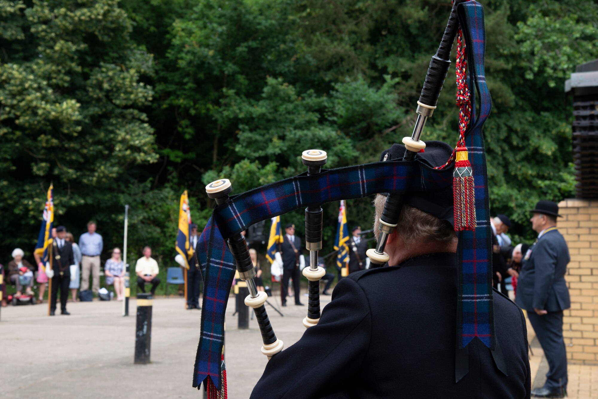 A bagpiper plays at the Desert Rats memorial in High Ash, Thetford Forest, England, July 11, 2021. Bagpipes were played before the 7th Armoured Division Desert Rats memorial prior to the U.S. Honor Guard members arrival to commemorate soldiers from the division who had fallen during World War II.  (U.S. Air Force photo by 1st Lt. Tyler Whiting)