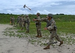 Maj. Gen. David Mikolaities, New Hampshire adjutant general, hurls a hatchet downrange during the New Hampshire National Guard's annual combat marksmanship competition July 10, 2021, at Fort Devens, Mass. The four-day match featured 14 teams and 75 marksmen competing in pistol, rifle, shotgun and even hatchet-throwing events.