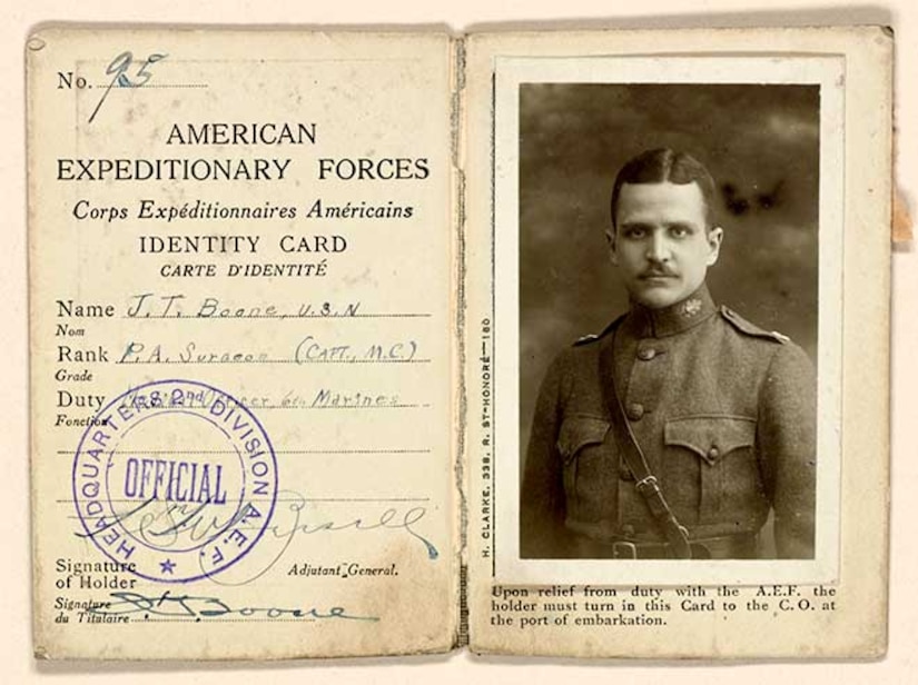 An identity card shows a man's photo and details of his name, military rank and duty.