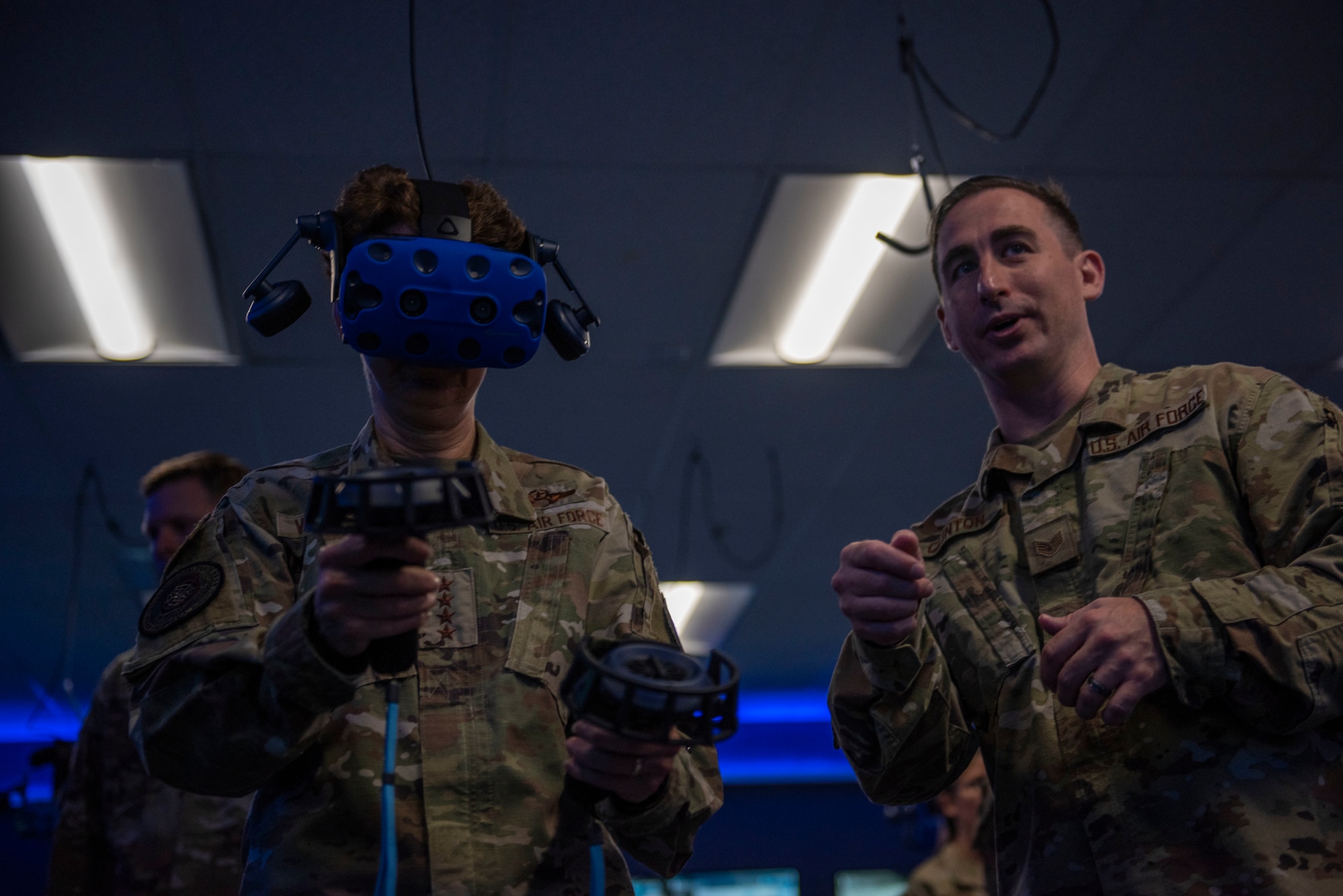 U.S. Air Force Staff Sgt. Christopher Clinton, 317th Maintenance Group virtual reality development NCO in charge, right, gives a VR training demonstration to Gen. Jacqueline Van Ovost, Air Mobility Command commander, at Dyess Air Force Base, Texas, July 8, 2021. Clinton briefed the AMC command team on the trials, benefits and data gathered from standing up the largest maintenance training VR lab in AMC. (U.S. Air Force photo by Senior Airman Colin Hollowell)