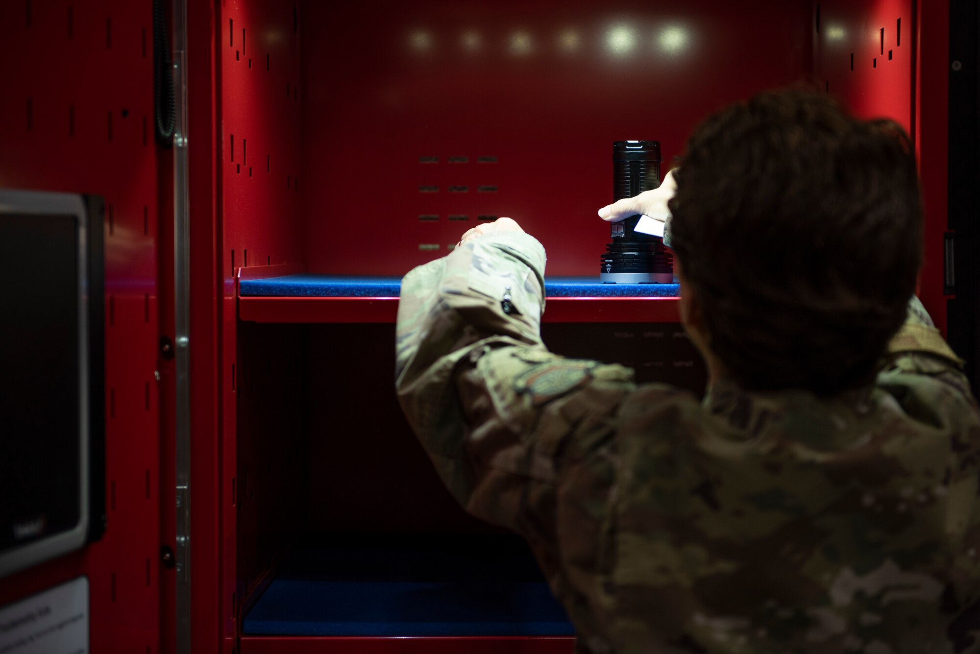 U.S. Air Force Gen. Jacqueline Van Ovost, Air Mobility Command commander, grabs tools from an automatic tool locker at Dyess Air Force Base, Texas, July 8, 2021. Van Ovost was briefed on the benefits of the tool locker, which automatically locks, issues and tracks aircraft maintenance tools that have been checked out and returned. (U.S. Air Force photo by Senior Airman Colin Hollowell)