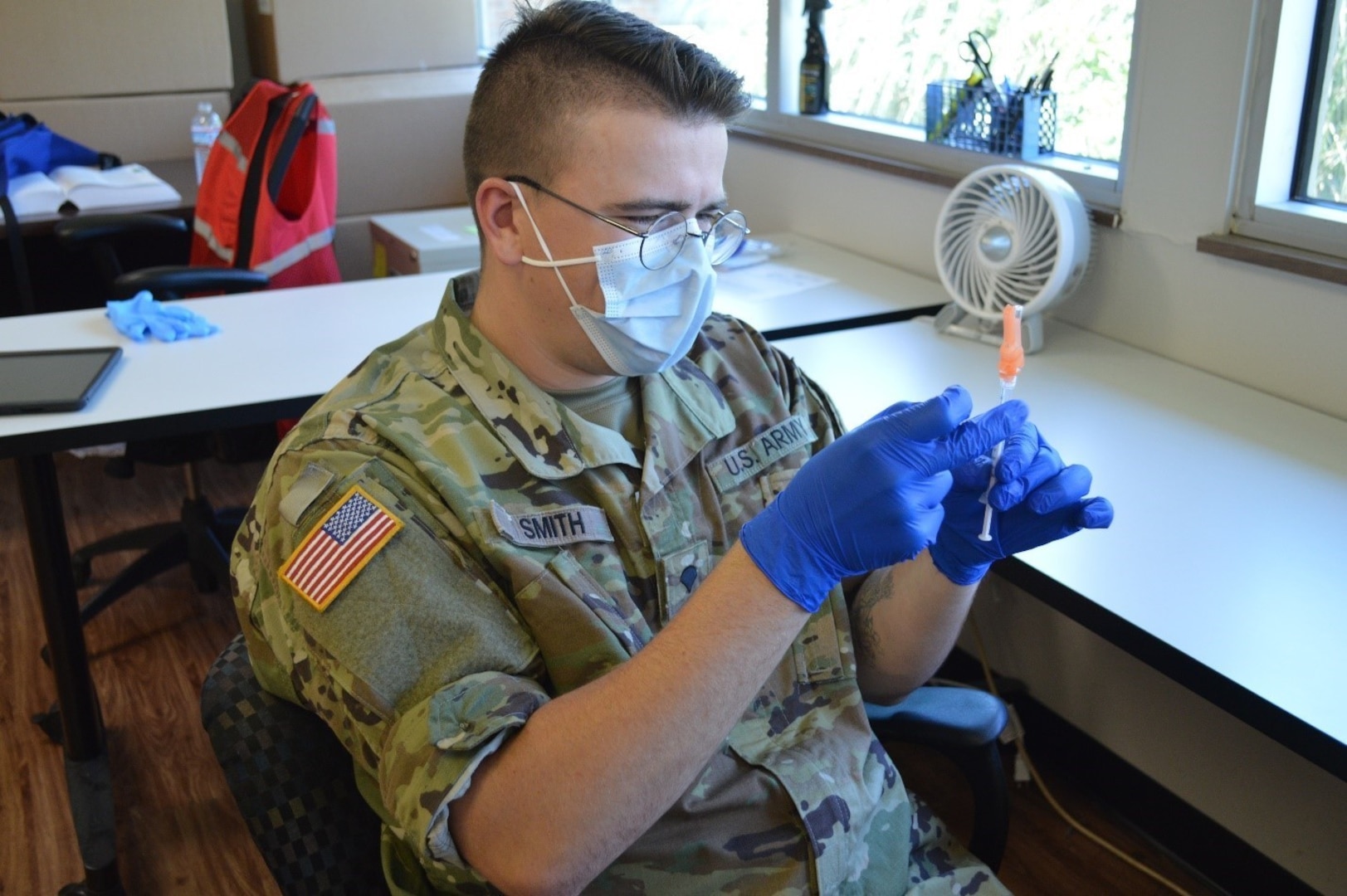 Spc. Alexander Smith, a combat medic with the 230th Sustainment Brigade, prepares a COVID-19 vaccine in Cleveland, Tenn. Smith has participated in the testing and vaccination phases of the Tennessee National Guard’s COVID-19 task force mission since March 2020.