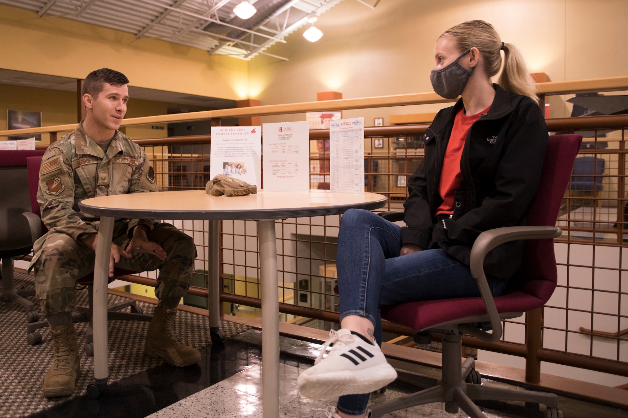 Missouri Air National Guard Staff Sgt. Tyler George, a logistics planner for the 131st Bomb Wing, chats with Eliza Cameron, a 131st Bomb Wing student flight member, July 10, 2021, at Whiteman Air Force Base, Missouri. George is Cameron's sponsor while in student flight. (U.S. Air National Guard photo by Airman 1st Class Whitney Erhart)