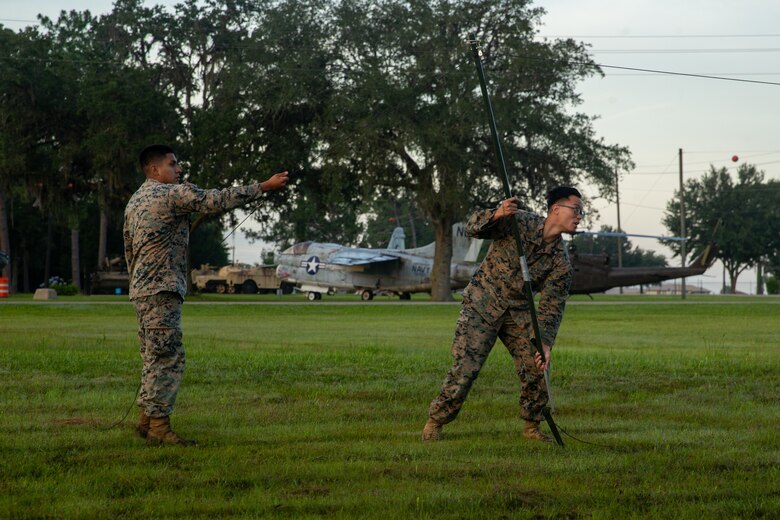 U.S. Marine Corps Cpl. Edwin Quitoguachichullca, left, a Chicago, Ill., native and a satellite transmissions systems operator, and Cpl. Dustin Nguyen, a Richmond, Va., native and transmissions systems operator with 1st Battalion, 2d Marine Regiment, 2d Marine Division (MARDIV), set up a field radio antenna as part of the 2d MARDIV High-Frequency (HF) Competition near Camp Blanding, Fla., July 13, 2021. The competition enhanced HF transmission proficiency and capabilities to prepare Marines for future expeditionary conflicts where the area is either contested or degraded. (U.S. Marine Corps photo by Lance Cpl. Brian Bolin Jr.)