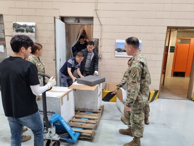 Soldiers and civilian personnel from the U.S. Army Medical Materiel Center-Korea assist in transporting important medical supplies from an Army prepositioned stocks site in Korea after a walk-in freezer broke June 24. (Staff Sgt. Anthony Peterson)