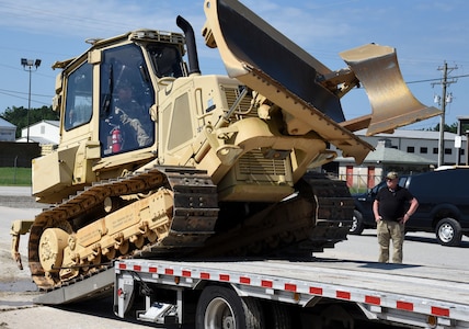 Virginia National Guard Soldiers assigned to the Fort Pickett-based Maneuver Area Training Equipment Site load a bulldozer onto a trailer for transport July 9, 2021, at Fort Pickett, Virginia. The bulldozer is part of the heavy equipment the Powhatan-based 180th Engineer Company, 276th Engineer Battalion, 329th Regional Support Group is taking for use during a training rotation July 10 - Aug. 3, 2021, at the Joint Readiness Training Center in Fort Polk, Louisiana.