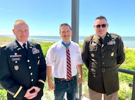 three men posing for a photo.