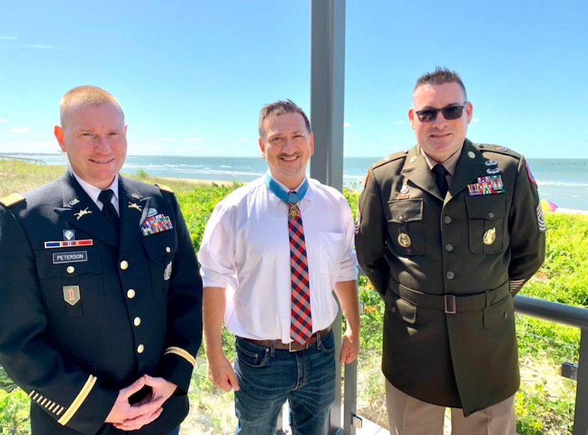 three men posing for a photo.