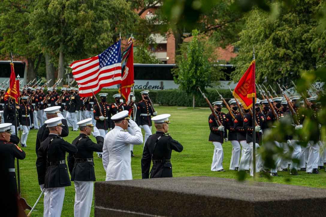 Marines with the Official U.S. Marine Corps Color Guard execute “pass in review” during the Tuesday Sunset Parade at the Marine Corps War Memorial, Arlington, Va., July 13, 2021. The hosting official for the evening was Brig. Gen. George B. Rowell IV, Director of Communication, Headquarters, Marine Corps, and the guest of honor was Vice Admiral Sean Buck, Superintendent of the United States Naval Academy. (U.S. Marine Corps photo by Lance Cpl. Allen Sanders)