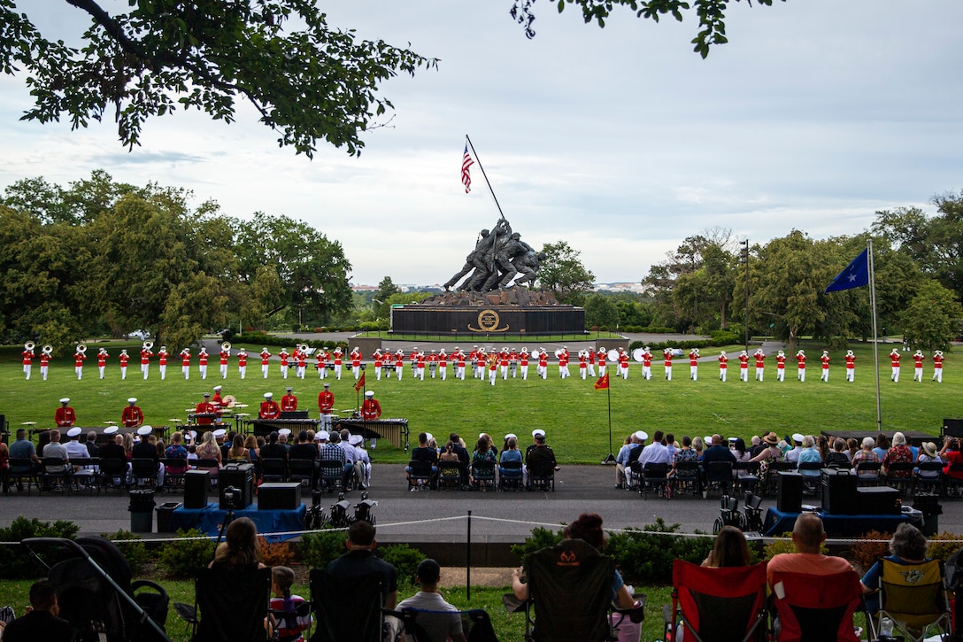 Marines with “The Commandant’s Own,” U.S. Marine Drum and Bugle Corps, perform during the Tuesday Sunset Parade at the Marine Corps War Memorial, Arlington, Va., July 13, 2021. The hosting official for the evening was Brig. Gen. George B. Rowell IV, Director of Communication, Headquarters, Marine Corps, and the guest of honor was Vice Admiral Sean Buck, Superintendent of the United States Naval Academy. (U.S. Marine Corps photo by Lance Cpl. Tanner D. Lambert)