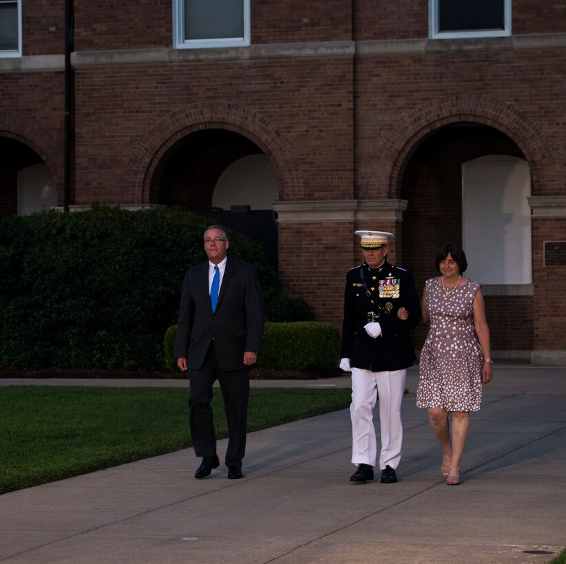 The Honorable Thomas W. Harker, Acting Secretary of the Navy, and Gen. David H. Berger, Commandant of the Marine Corps, and his wife, walk down Center Walk during the Friday Evening Parade at Marine Barracks Washington, July 9, 2021.