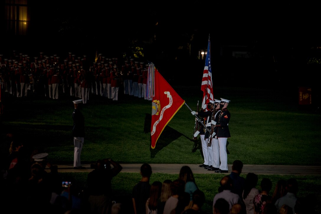 Marines with the Official U.S. Marine Corps Color Guard present the National Ensign during the Friday Evening Parade at Marine Barracks Washington, July 9, 2021. The hosting official for the evening was Gen. David H. Berger, Commandant of the Marine Corps, and the guest of honor was The Honorable Thomas W. Harker, Acting Secretary of the Navy. (U.S. Marine Corps photo by Lance Cpl. Mark Morales)