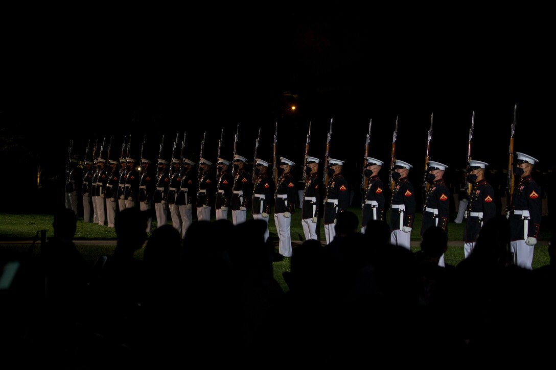 Marines with the Silent Drill Platoon execute their “long line” sequence during the Friday Evening Parade at Marine Barracks Washington, July 9, 2021. The hosting official for the evening was Gen. David H. Berger, Commandant of the Marine Corps, and the guest of honor was The Honorable Thomas W. Harker, Acting Secretary of the Navy. (U.S. Marine Corps photo by Lance Cpl. Mark Morales)