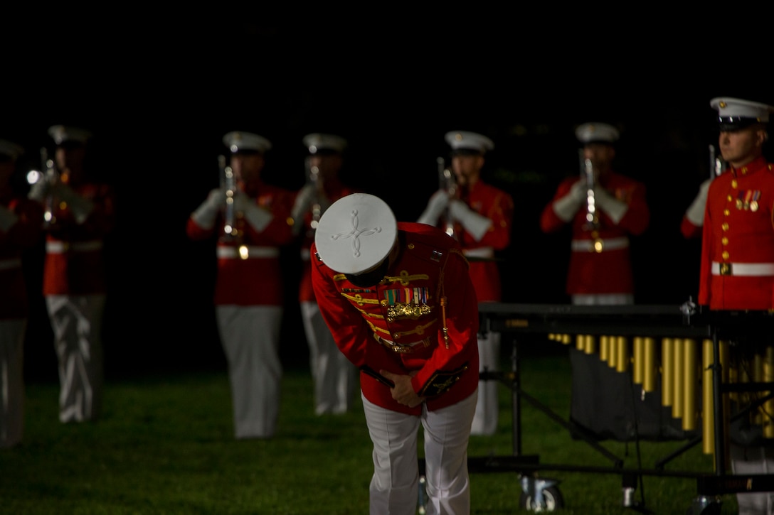 Captain Nathan D. Morris, assistant director, “The Commandant’s Own” Drum and Bugle Corps, bows during the Friday Evening Parade at Marine Barracks Washington, July 9, 2021. The hosting official for the evening was Gen. David H. Berger, Commandant of the Marine Corps, and the guest of honor was The Honorable Thomas W. Harker, Acting Secretary of the Navy. (U.S. Marine Corps photo by Lance Cpl. Mark Morales)