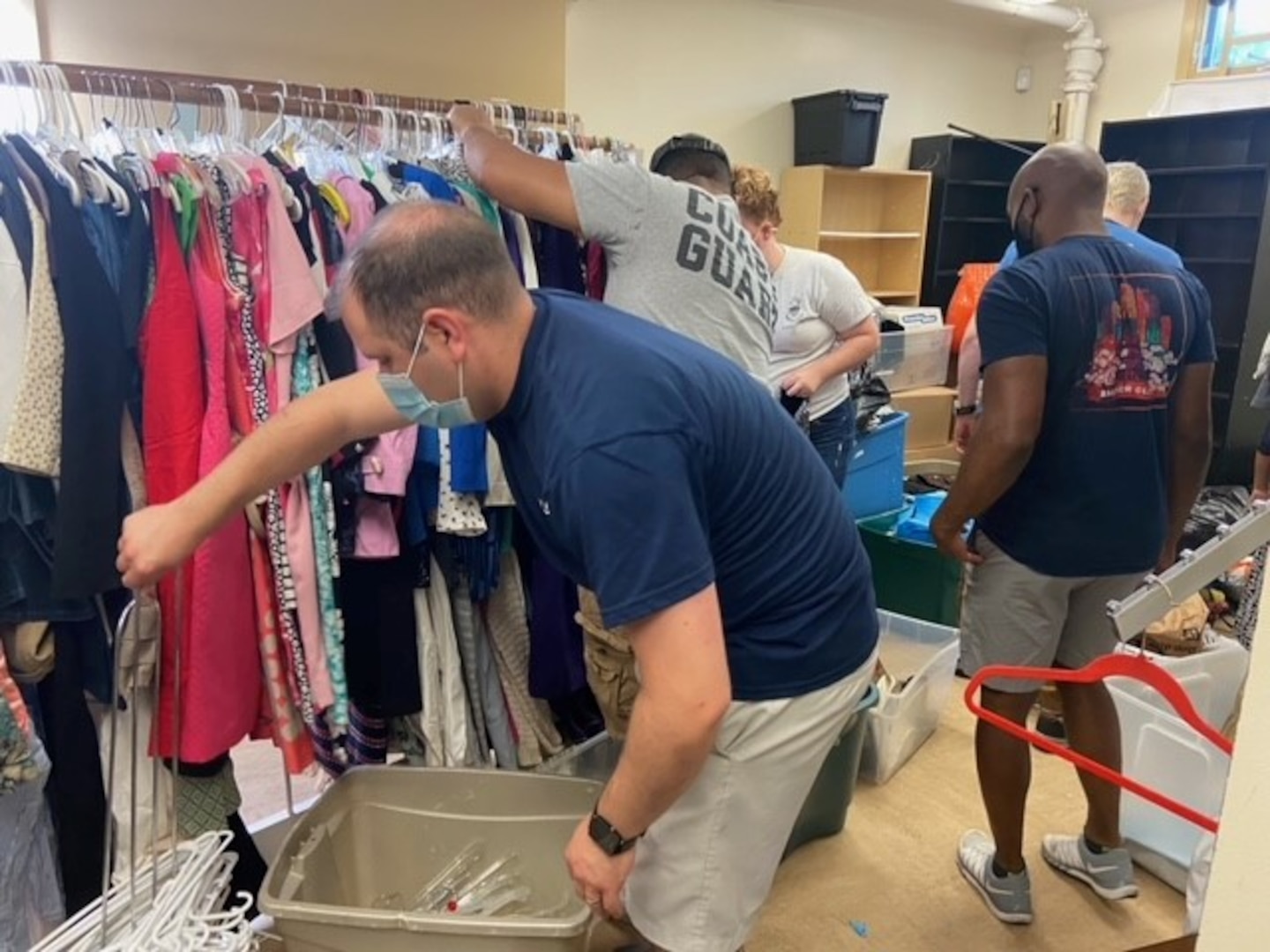 Coast Guard volunteers participate in Feds Feed Families while helping sort clothes at Bread for the City on June 29. The clothes will be made available for free to the needy in the community. Photo by Kyah Campbell, volunteer coordinator, Bread for the City, SE.
