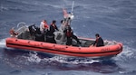 The Coast Guard Cutter Thetis’ crewmembers deploy the cutter’s small boat to rescue people in the water approximately 32 miles southeast of Key West, Florida, July 7, 2021. The Coast Guard and a good Samaritan rescued 13 people from the water. (U.S. Coast Guard photo by Coast Guard Cutter Thetis crew)