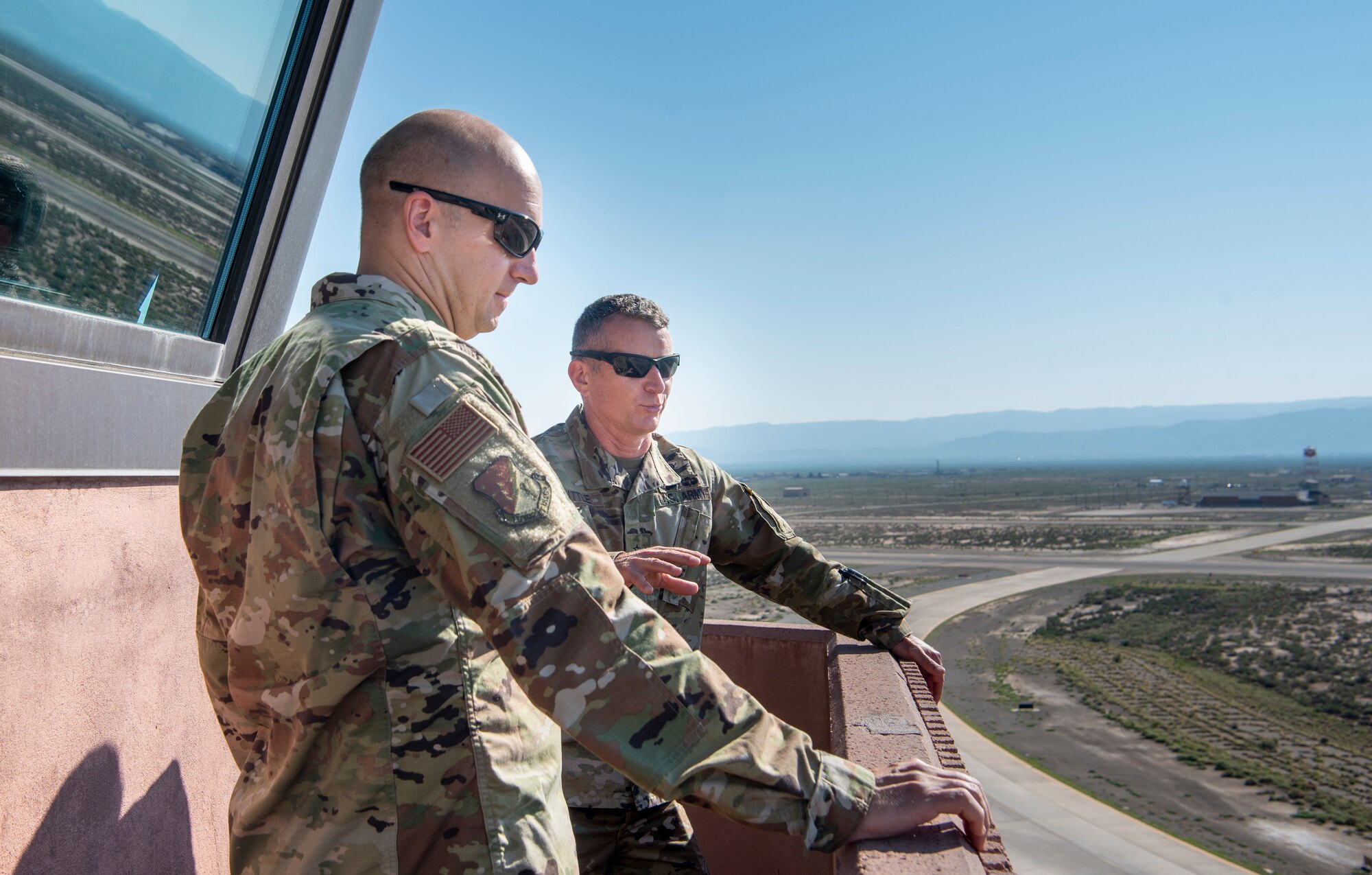 U.S. Air Force Col. Ryan Keeney, 49th Wing commander, and U.S. Army Brig. Gen. Eric Little, White Sands Missile Range commander, observe the airfield July 9, 2021, on Holloman Air Force Base, New Mexico. Little visited Holloman AFB to familiarize with local operations and tour partner units. (U.S. Air Force photo by Airman 1st Class Jessica Sanchez)