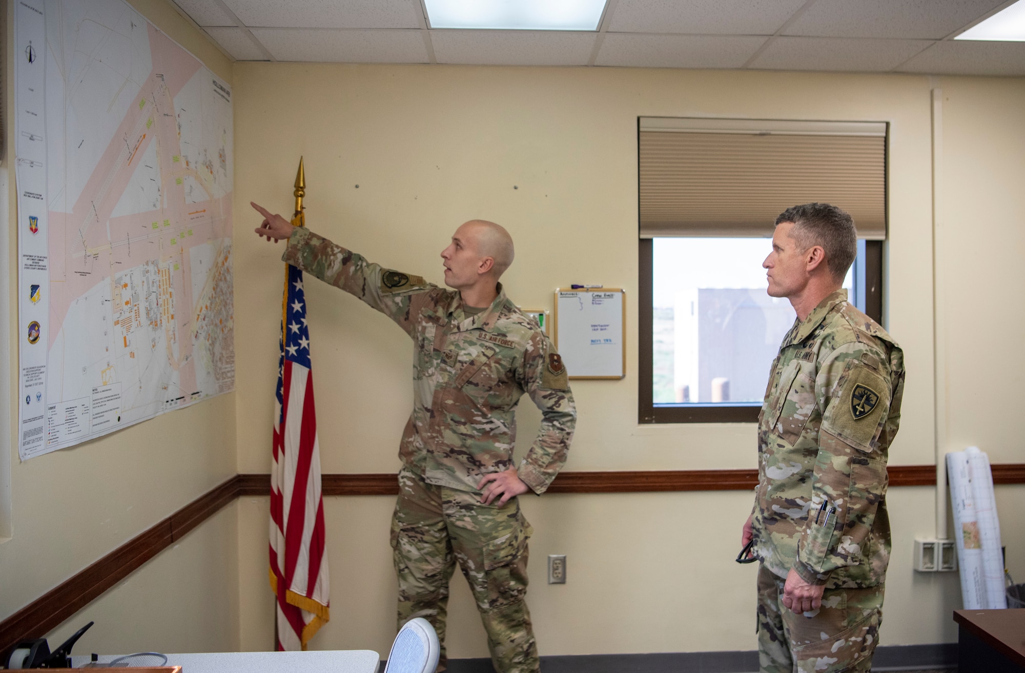 U.S. Air Force Staff Sgt. Corey Jones, 54th Operations Support Squadron tower watch supervisor, shows U.S. Army Brig. Gen. Eric Little, White Sands Missile Range commander, a map of Holloman’s airfield, July 9, 2021, on Holloman Air Force Base, New Mexico. Little visited Holloman AFB to familiarize with local operations and tour partner units. (U.S. Air Force photo by Airman 1st Class Jessica Sanchez)