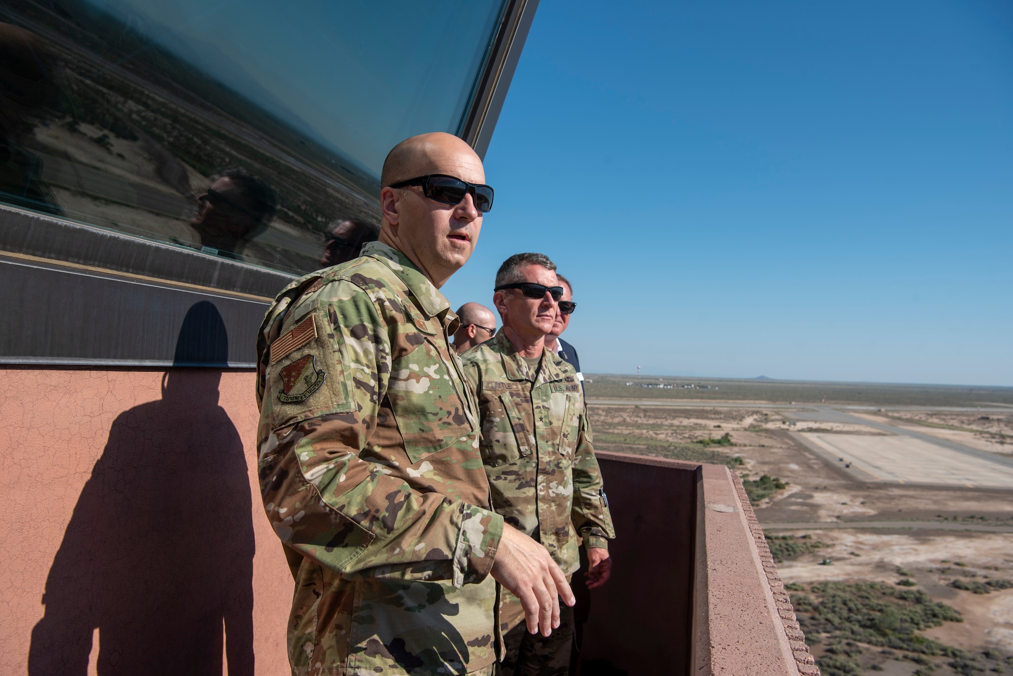 U.S. Air Force Col. Ryan Keeney, 49th Wing commander, and U.S. Army Brig. Gen. Eric Little, White Sands Missile Range commander, observe the airfield, July 9, 2021, on Holloman Air Force Base, New Mexico. Little visited Holloman AFB to familiarize with local operations and tour partner units. (U.S. Air Force photo by Airman 1st Class Jessica Sanchez)