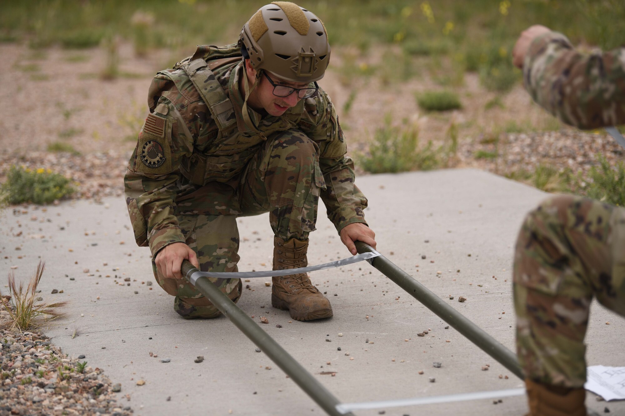 Senior Airman Tommy Gordon, a Pavement and Equipment Operator with the 90th Civil Engineering Squadron, practices proper assembly of equipment that would go toward the retrieval of an injured person during the 90 CES Readiness Challenge on F.E. Warren Air Force Base, Wyoming, July 1, 2021. The purpose of the exercise was to train the readiness capabilities of the Airmen with the 90 CES. (U.S. Air Force photo by Airman 1st Class Darius Frazier)