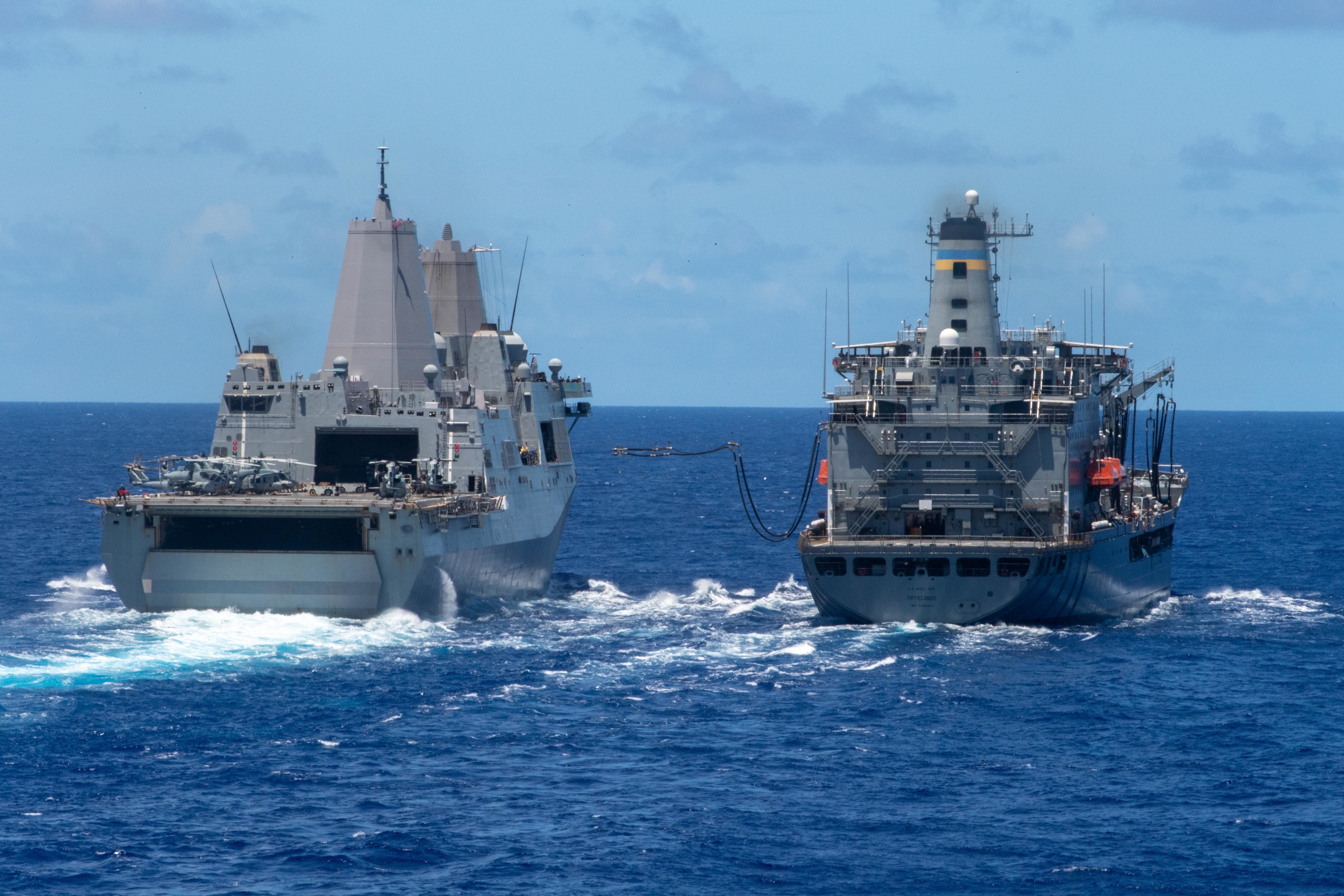 Amphibious transport dock USS New Orleans (LPD 18) (left) recieves fuel lines from USNS Tippecanoe (T-AO 199).