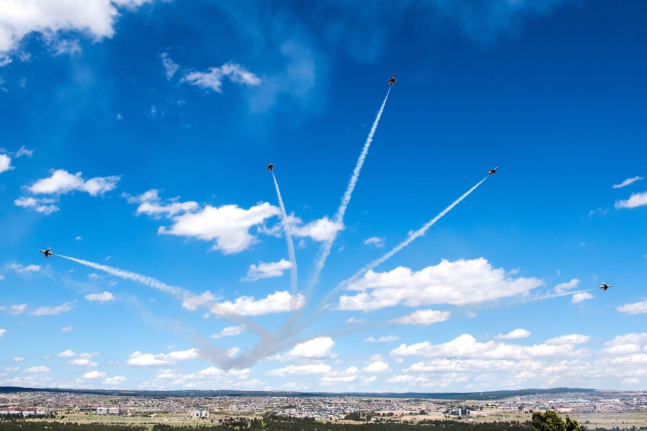 Aircraft fly in formation.