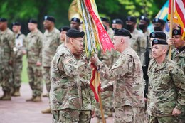 general officer hands colors to another general officer