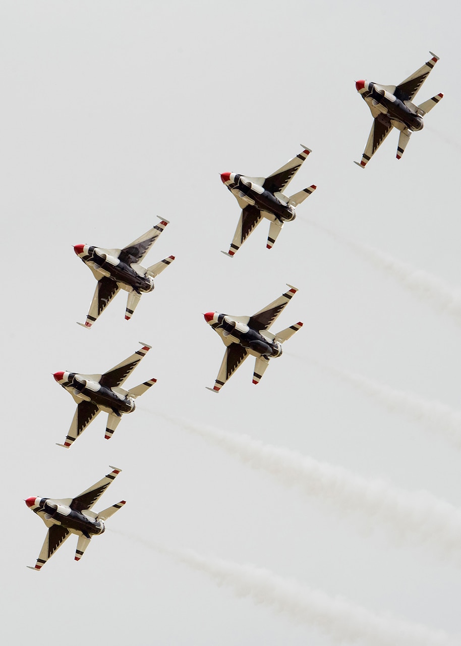 Aircraft fly in formation.