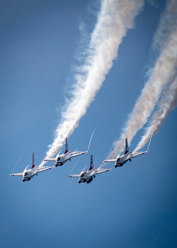 Aircraft fly in formation.