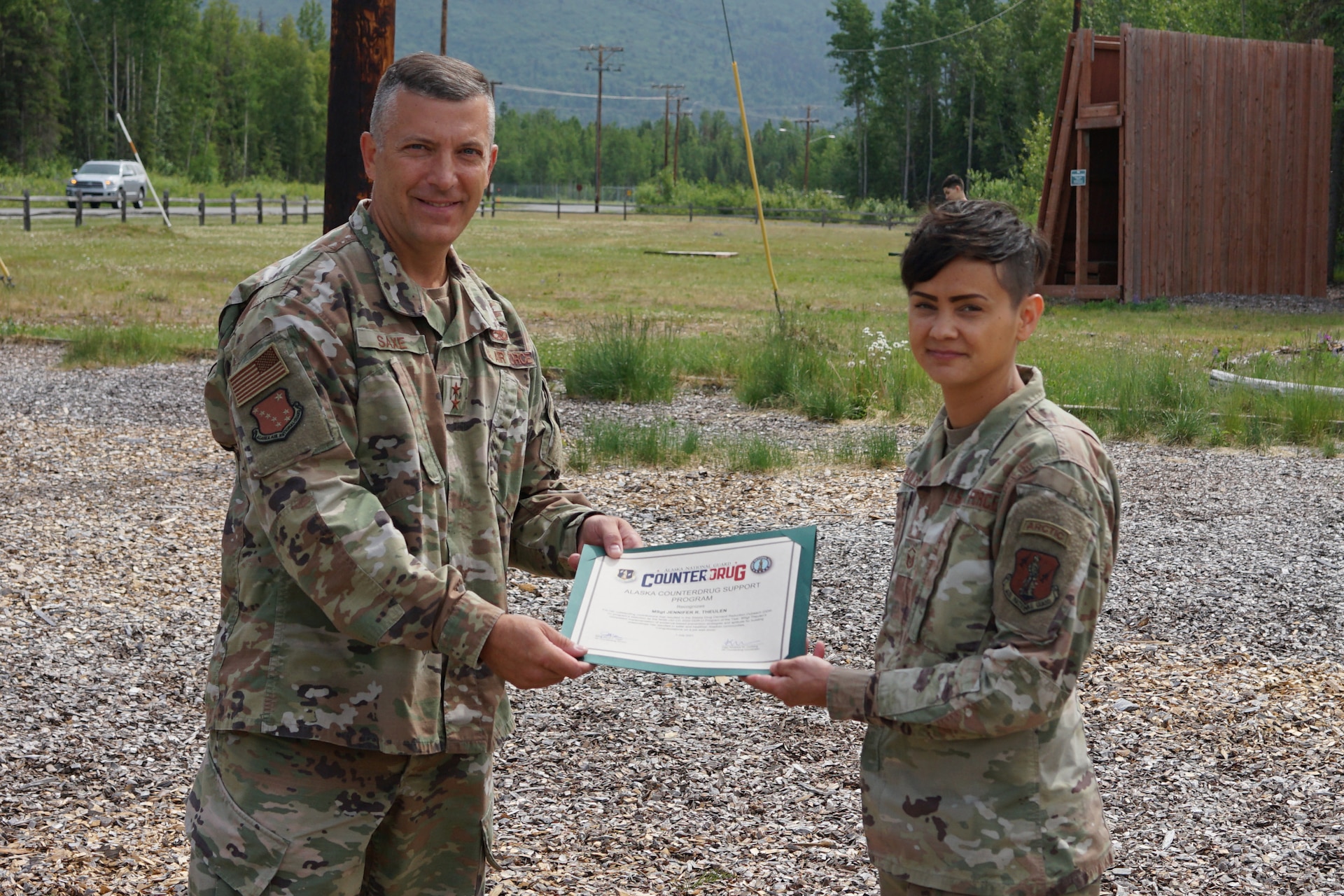 Maj. Gen. Torrence Saxe, commissioner for the Department of Military and Veterans Affairs and adjutant general of the Alaska National Guard, presents the National Guard Drug Demand Reduction Outreach Program of the Year for 2020 certificate to Master Sgt. Jennifer Theulen, Alaska National Counter Drug program coordinator, July 1, 2021.The Alaska National Guard Counter Drug Program was selected as the National Guard Drug Demand Reduction Outreach Program of the Year for 2020. The Counter Drug Program supports the Alaska National Guard efforts and initiatives to prevent drug abuse/misuse through prevention, education, outreach, and to detect and deter DoD military and civilian personnel from using illicit drugs or misusing prescription drugs.