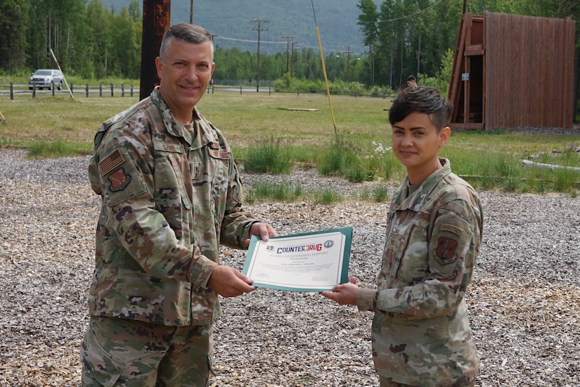 Maj. Gen. Torrence Saxe, commissioner for the Department of Military and Veterans Affairs and adjutant general of the Alaska National Guard, presents the National Guard Drug Demand Reduction Outreach Program of the Year for 2020 certificate to Master Sgt. Jennifer Theulen, Alaska National Counter Drug program coordinator, July 1, 2021.The Alaska National Guard Counter Drug Program was selected as the National Guard Drug Demand Reduction Outreach Program of the Year for 2020. The Counter Drug Program supports the Alaska National Guard efforts and initiatives to prevent drug abuse/misuse through prevention, education, outreach, and to detect and deter DoD military and civilian personnel from using illicit drugs or misusing prescription drugs.