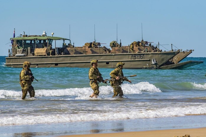 Australian Army soldiers, of 2nd Batallion, the Royal Australian Regiment, approach Langham Beach, Queensland, during Talisman Sabre 2019.
