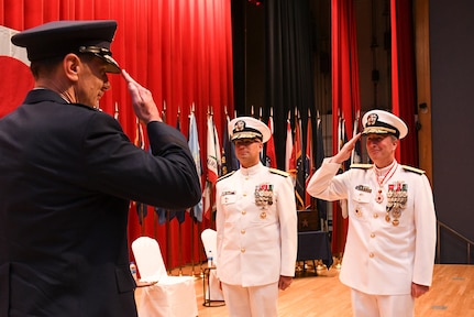 Rear Adm. Brian P. Fort (right) salutes Lt. Gen. Kevin B. Schneider, Commander, U.S. Forces, Japan, and Commander, Fifth Air Force, Pacific Air Forces, Yokota Air Base, Japan, during a change of command ceremony July 14 at Commander, Fleet Activities Yokosuka Fleet Theater. Rear Adm. Carl A. Lahti became the 36th commander of CNFJ and CNRJ. Schneider served as the guest speaker for the ceremony.