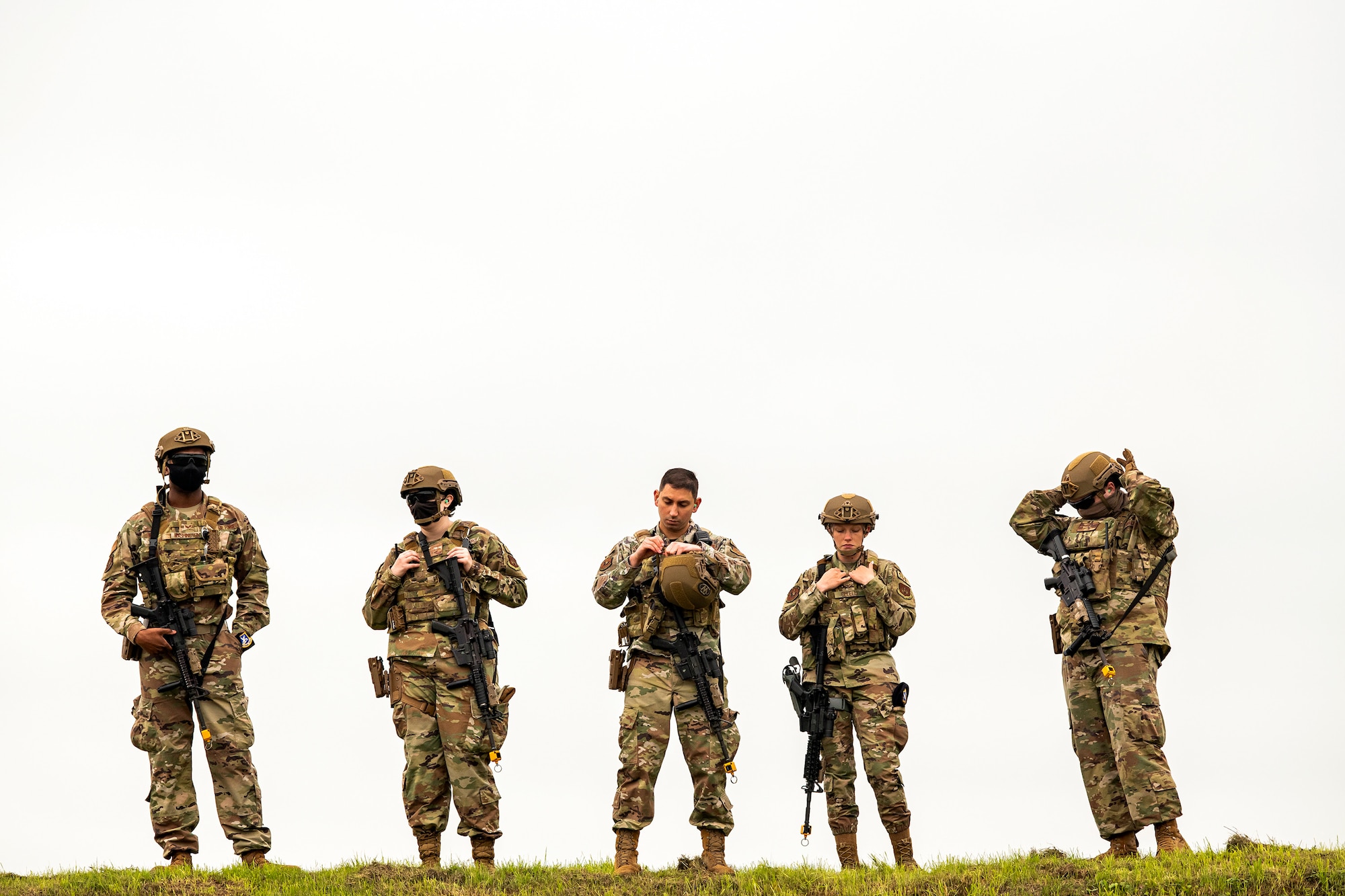 Airmen from the 422nd Security Forces Squadron, gear up prior to a tri-agency active shooter response exercise at RAF Croughton, England, June 30, 2021. Airmen from the 422nd SFS along with police officers from the Northamptonshire Police Department and Ministry of Defense, participated in multiple exercises to enhance their search and seizure tactics, strengthen local ties and gain rapport with their fellow officers. (U.S. Air Force photo by Senior Airman Eugene Oliver)