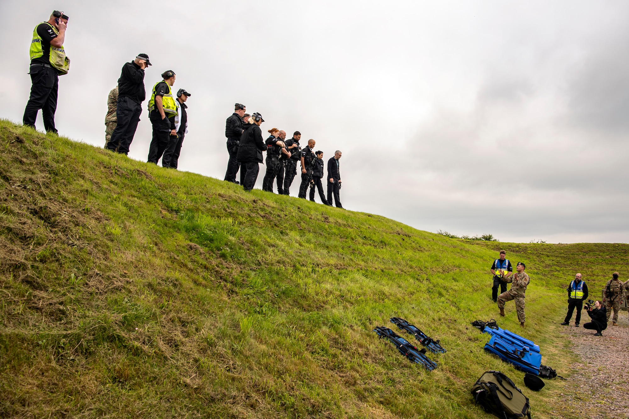 Staff Sgt. Carlos Sandoval, right, 422nd Security Forces Squadron unit trainer, speaks with police officers from the Northamptonshire Police department prior to a tri-agency active shooter response exercise at RAF Croughton, England, June 30, 2021. Airmen from the 422nd SFS along with police officers from the NHPD and Ministry of Defense, participated in multiple exercises to enhance their search and seizure tactics, strengthen local ties and gain rapport with their fellow officers. (U.S. Air Force photo by Senior Airman Eugene Oliver)