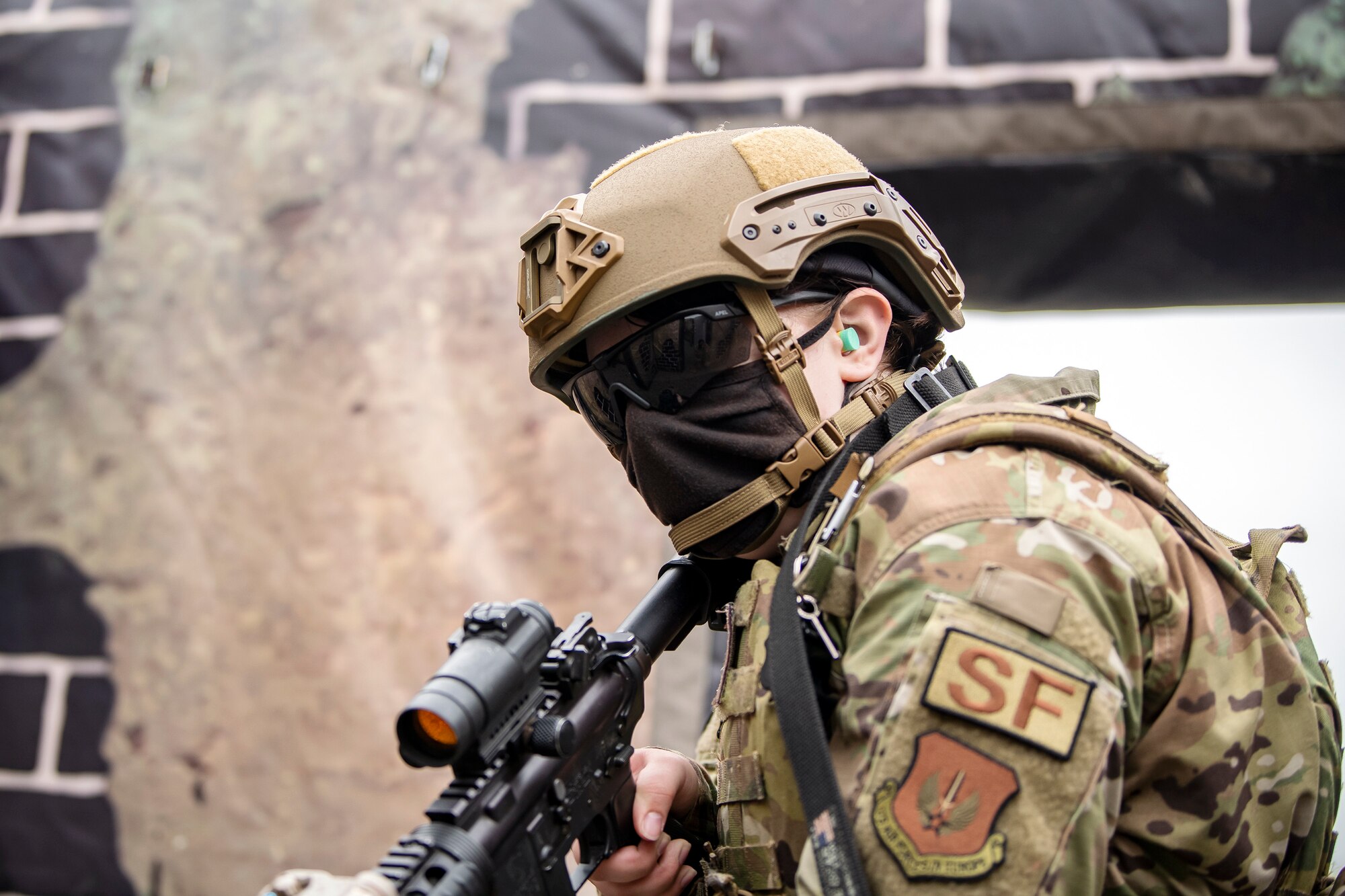 An Airman from the 422nd Security Forces Squadron, scans her perimeter during a tri-agency active shooter response exercise at RAF Croughton, England, June 30, 2021. Airmen from the 422nd SFS along with police officers from the Northamptonshire Police Department and Ministry of Defense, participated in multiple exercises to enhance their search and seizure tactics, strengthen local ties and gain rapport with their fellow officers. (U.S. Air Force photo by Senior Airman Eugene Oliver)