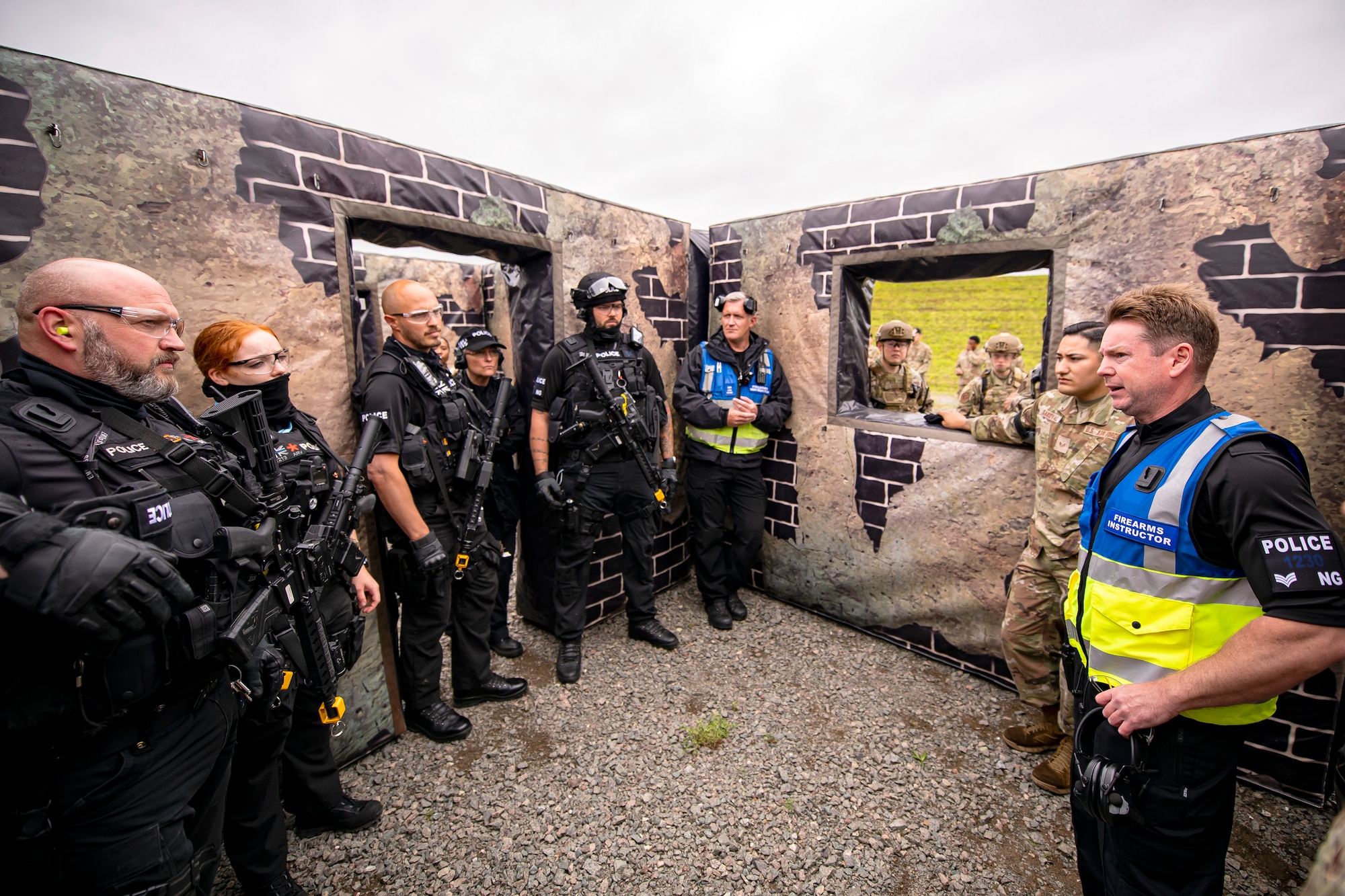 Northamptonshire Police Department sergeant Wayne Dowson, right, armed police training manager, speaks with police officers from the NHPD and Airmen from the 422nd Security Forces Squadron after a tri-agency active shooter response exercise at RAF Croughton, England, June 30, 2021. Airmen from the 422nd SFS along with police officers from the NHPD and Ministry of Defense, participated in multiple exercises to enhance their search and seizure tactics, strengthen local ties and gain rapport with their fellow officers. (U.S. Air Force photo by Senior Airman Eugene Oliver)