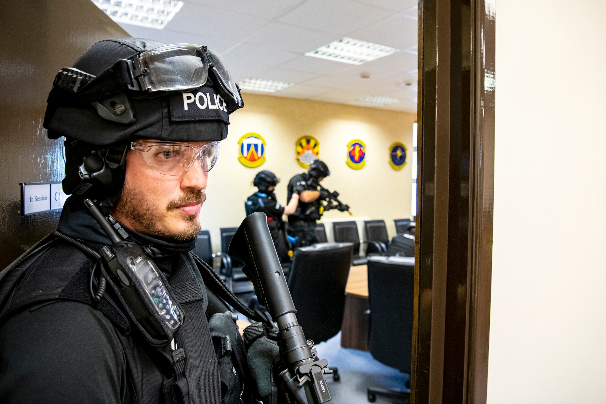 Police officers from the Northamptonshire Police Department, conduct a tri-agency active shooter response exercise at RAF Croughton, England, June 30, 2021. Airmen from the 422nd Security Forces Squadron along with police officers from the NHPD and Ministry of Defense, participated in multiple exercises to enhance their search and seizure tactics, strengthen local ties and gain rapport with their fellow officers. (U.S. Air Force photo by Senior Airman Eugene Oliver)