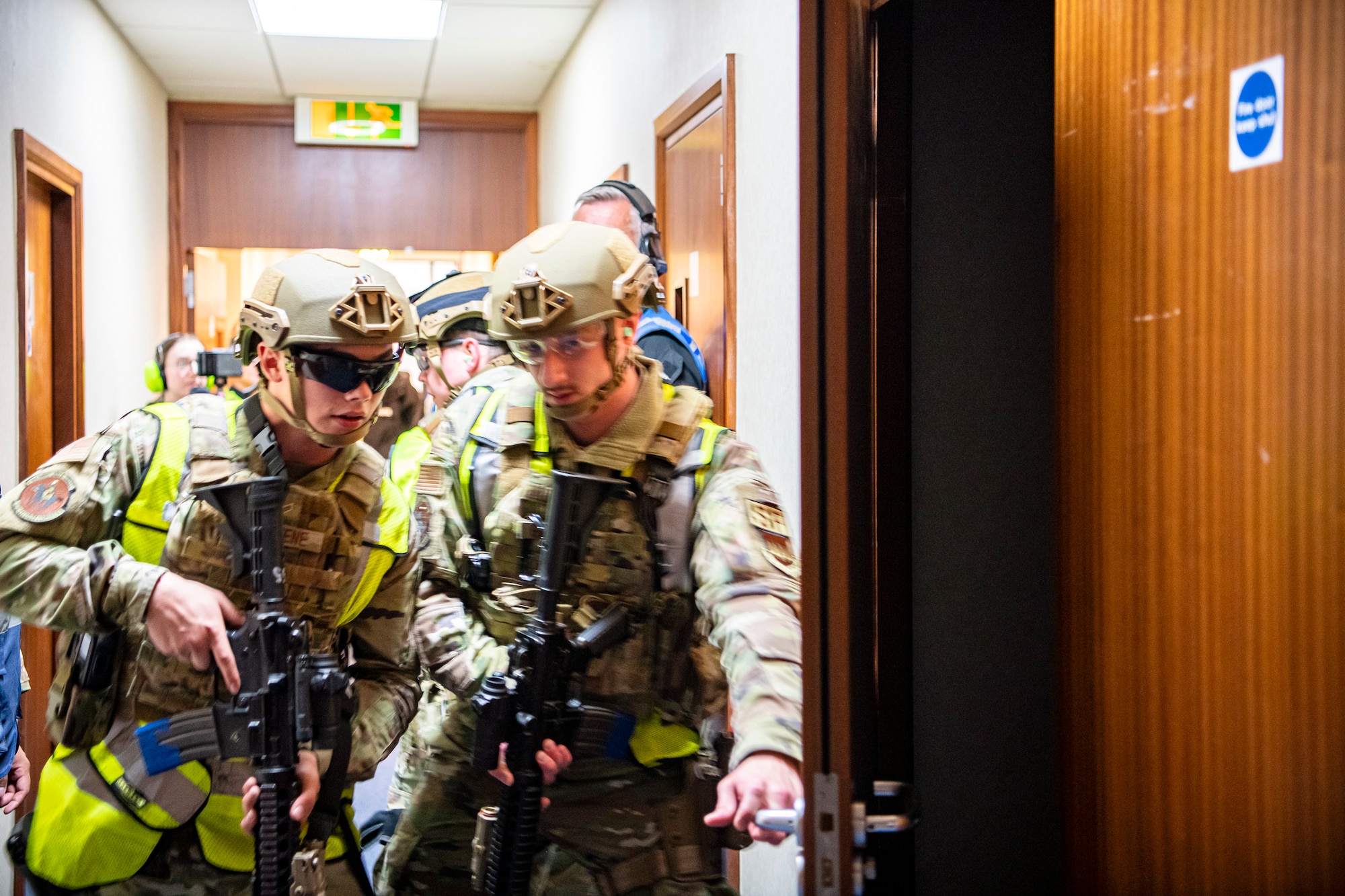 Airmen from the 422nd Security Forces Squadron, prepare to clear a room as part of a tri-agency active shooter response exercise at RAF Croughton, England, June 30, 2021. Airmen from the 422nd SFS along with police officers from the Northamptonshire Police Department and Ministry of Defense, participated in multiple exercises to enhance their search and seizure tactics, strengthen local ties and gain rapport with their fellow officers. (U.S. Air Force photo by Senior Airman Eugene Oliver)