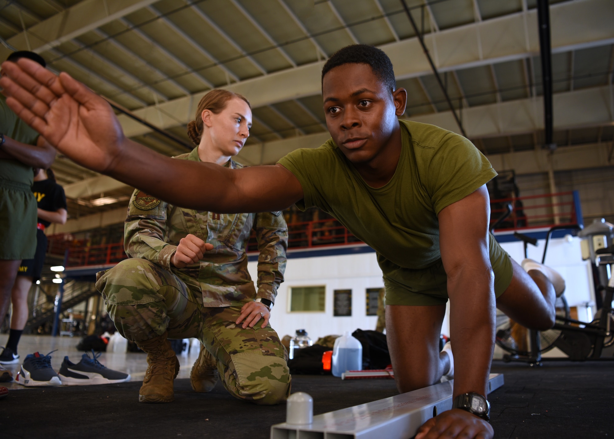 U.S. Air Force Capt. Danielle Langness, 17th Medical Group physical therapist, assesses a student's functional movements on Goodfellow Air Force Base, Texas, June 30, 2021. Students of the 312th Training Squadron were evaluated in physical and mental aspects before starting their technical training at the Louis F. Garland Department of Defense Fire Academy. (U.S. Air Force photo by Senior Airman Abbey Rieves)