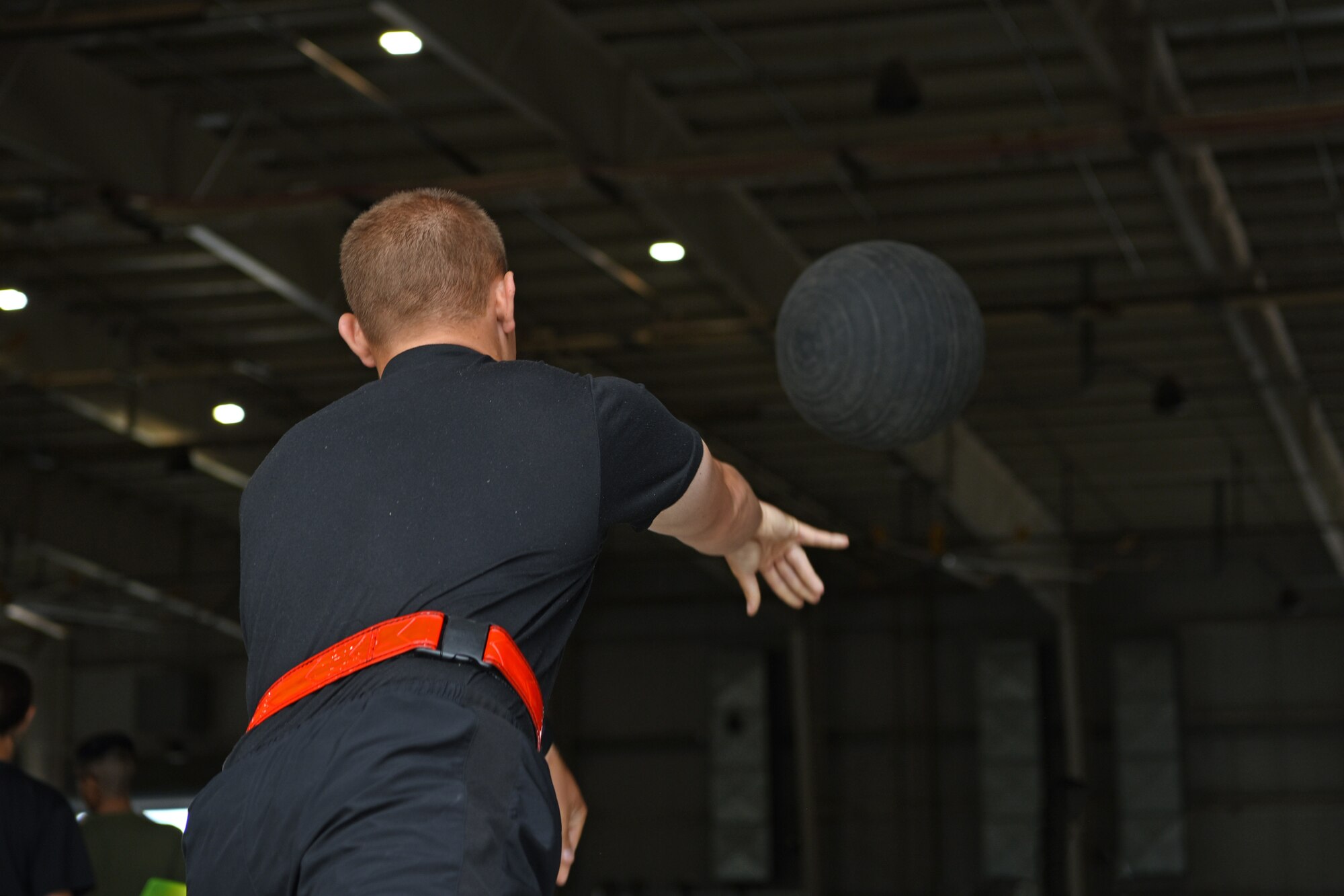 U.S. Army Firefighter Detachment student assigned to the 169th Engineer Battalion, throws a medicine ball for an evaluation, on Goodfellow Air Force Base, Texas, June 30, 2021. Firefighter students were assessed before they started their course by a physical therapist to fix lifting mechanics or strength deficits to prevent injury. (U.S. Air Force photo by Senior Airman Abbey Rieves)