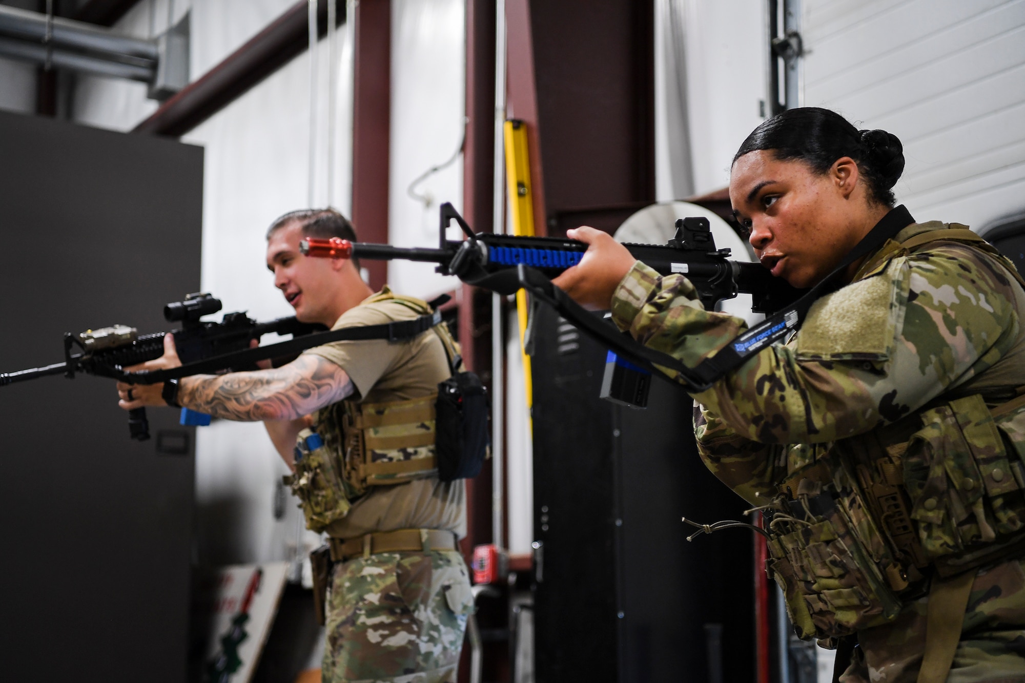 Airman 1st Class Hailey Farver, 66th Security Forces Squadron entry controller, and Staff Sgt. Caleb Kenley, partner during a shoot, communicate, and move training at Hanscom Air Force Base, Mass., June 29. The newest issue of body armor was designed specifically to fit females during combat and contingency operations. (U.S. Air Force photo by Lauren Russell)