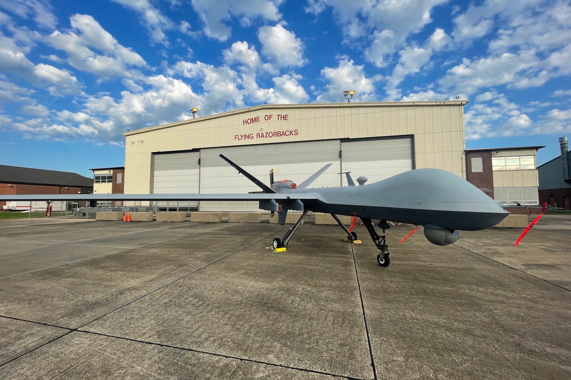 An MQ-9 From the 147th Attack Wing sits in front of a hanger on the 188th Wing flight line.  Exercise Establish Fury marks the first time an MQ-9 Landed and launched from the Airfield in Fort Smith Arkansas.