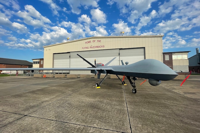 An MQ-9 From the 147th Attack Wing sits in front of a hanger on the 188th Wing flight line.  Exercise Establish Fury marks the first time an MQ-9 Landed and launched from the Airfield in Fort Smith Arkansas.